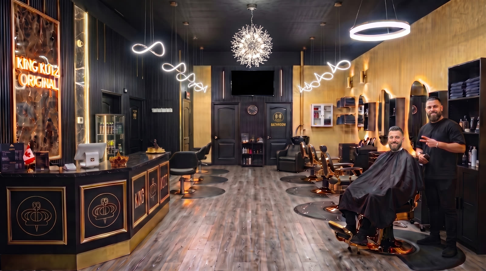 Rowaid Hanna giving a peace sign in the centre aisle of King Kutz Original, a black-and-gold barbershop at night, a gold crown floating above his head.
